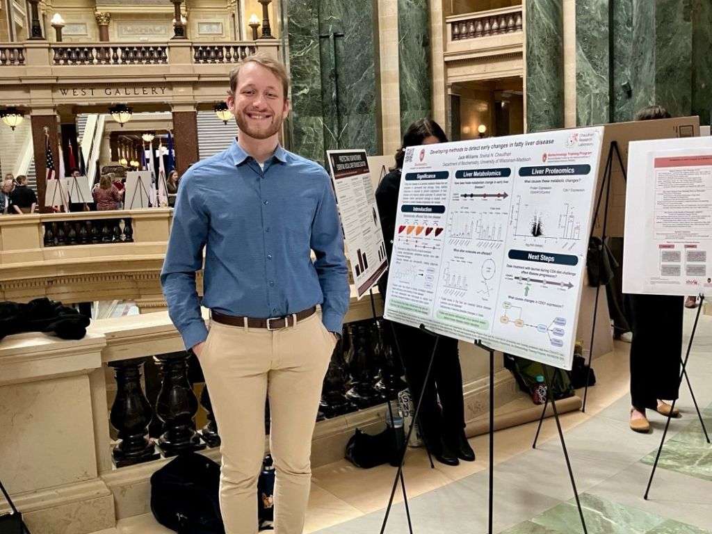 Jack Williams presents a poster – Researcher presenting a scientific poster at the Wisconsin State Capitol for UW–Madison Day 2025